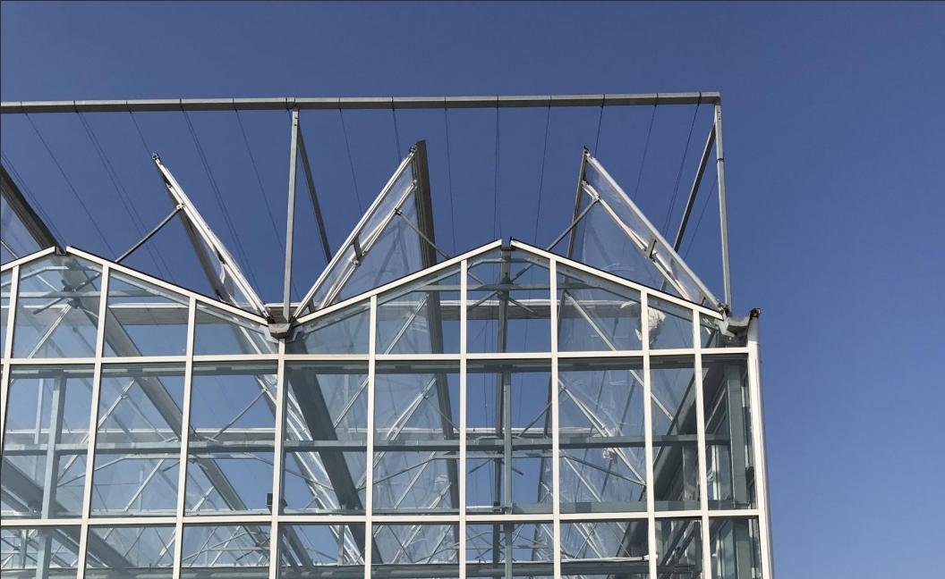 What are the Functions of a Smart Climate Control System in a Glass Greenhouse?