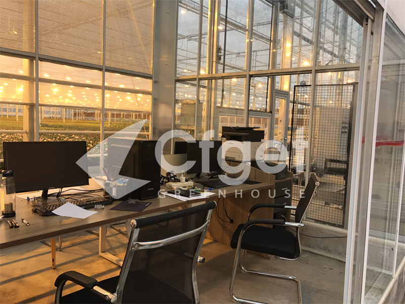 Inspected CFGET greenhouse control room beside a lit production area
