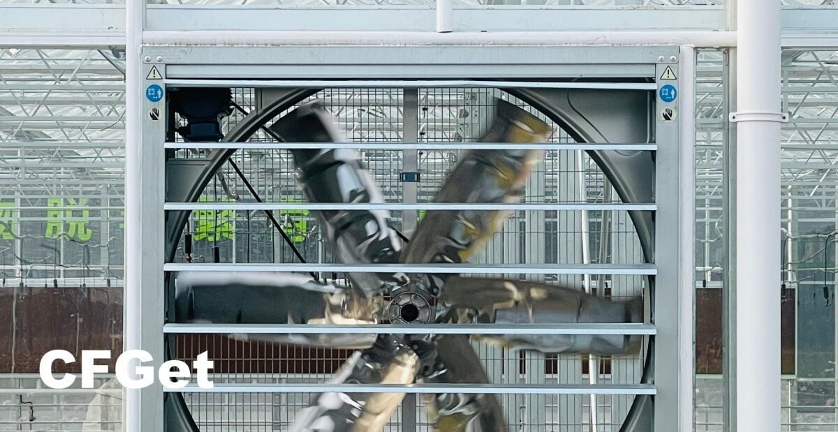 CFGET greenhouse exhaust fan operating behind a safety guard and inlet shutter system