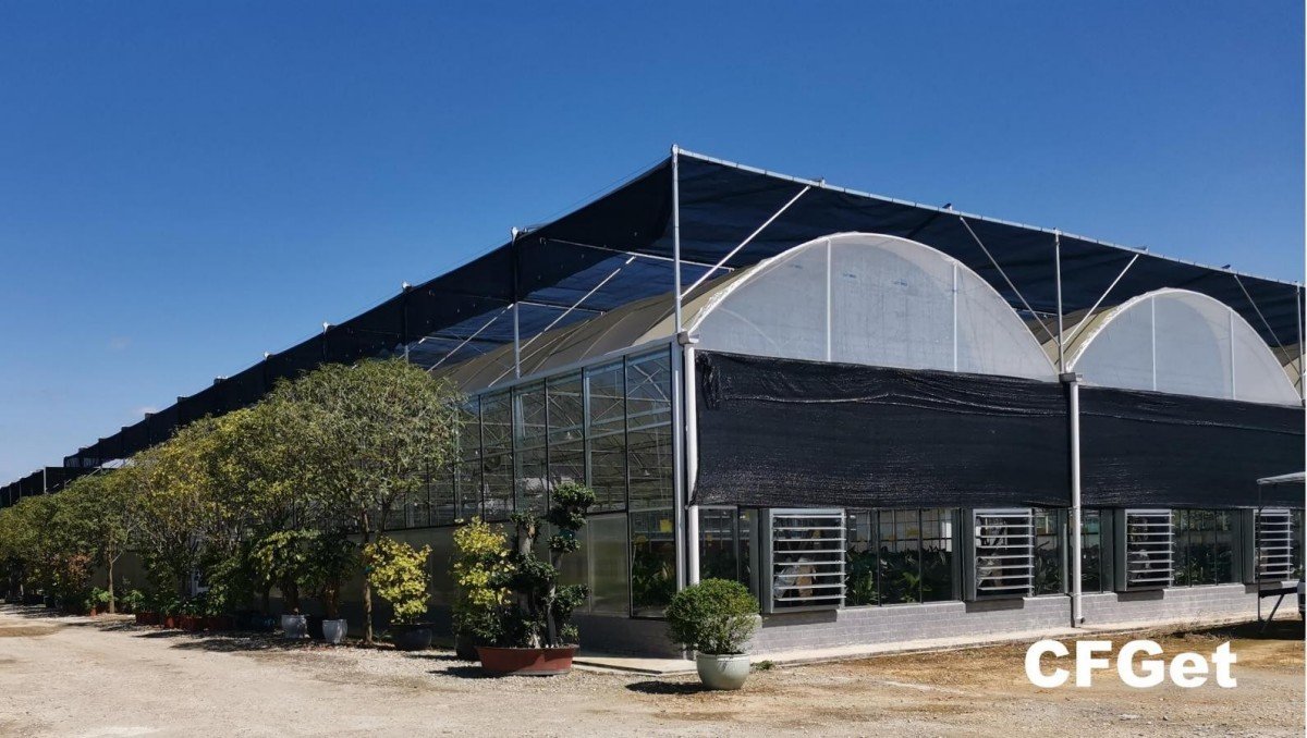 CFGET commercial greenhouse exterior with a row of exhaust fan and shutter openings