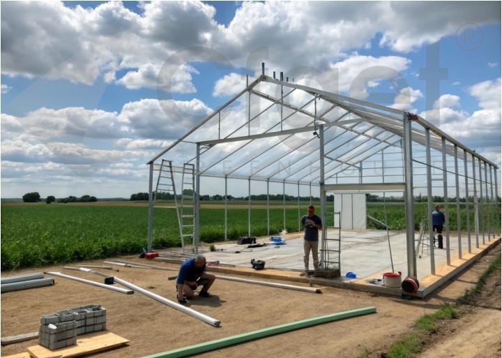 CFGET greenhouse frame being assembled on a prepared foundation and floor