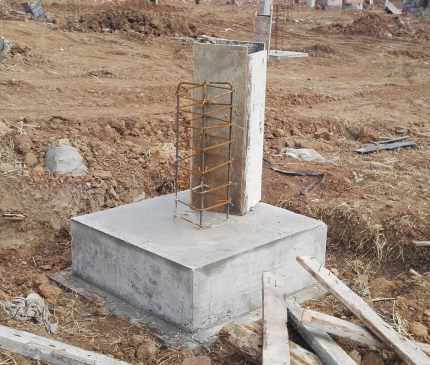Concrete greenhouse column footing with reinforcing steel during construction