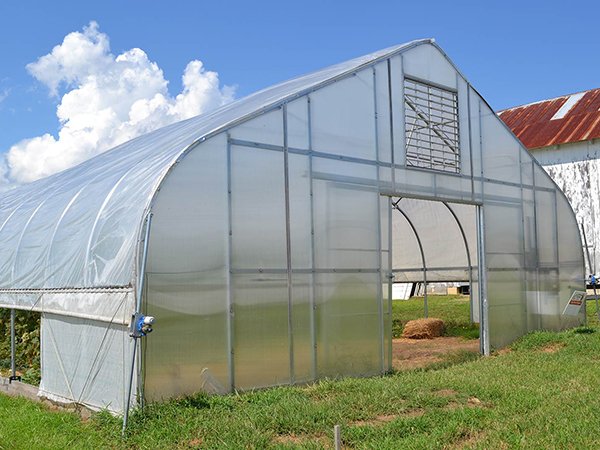 Existing CFGET gothic greenhouse project in Norway with a curved roof, end-wall framing and side ventilation hardware